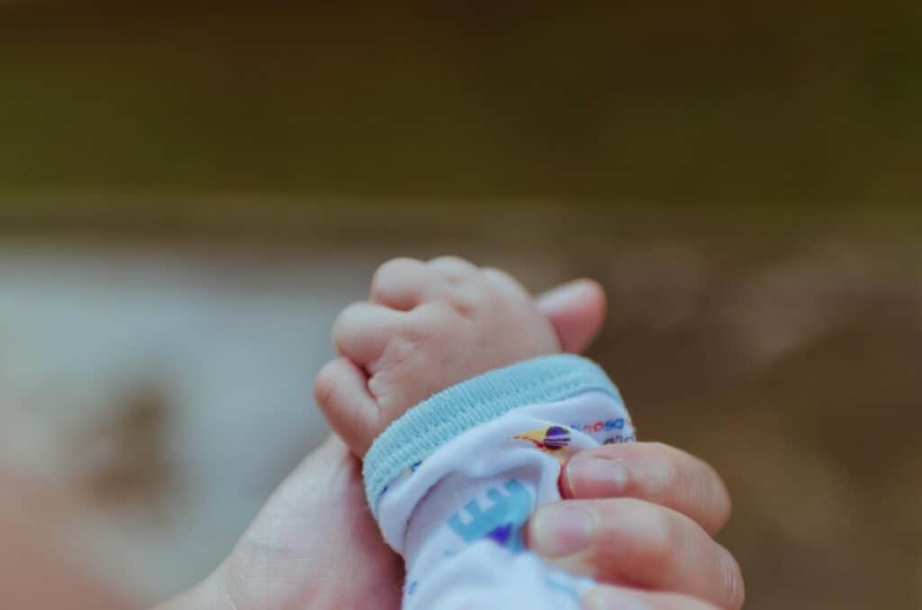 person holding baby's hand - What I Do When My Toddler Has A Fever But No Other Symptoms